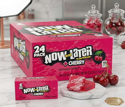 Box of Now and Later Cherry candy with individual bars on a marble surface.